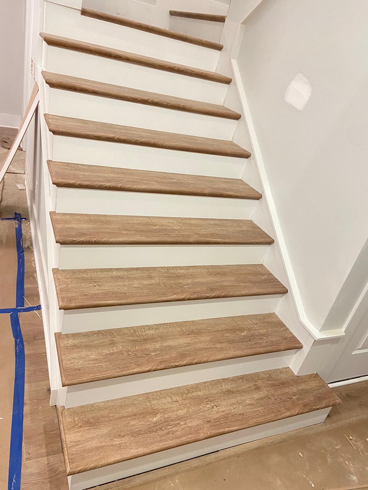 Full flight of oak stairs with white skirt boards
