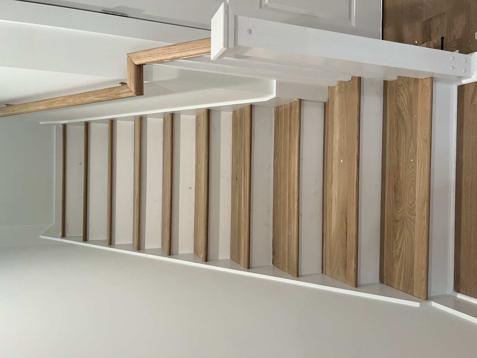 White oak staircase with matching handrail, straight-on view